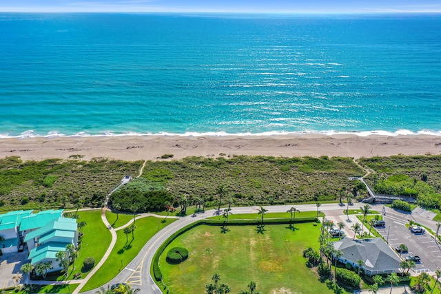 drone / aerial view with a water view and a beach view