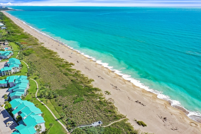 birds eye view of property with a beach view and a water view