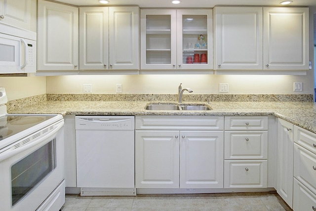 kitchen with sink, white cabinets, and white appliances