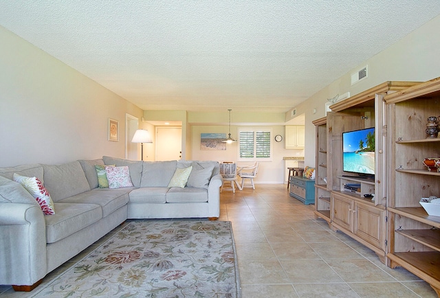 tiled living room with a textured ceiling