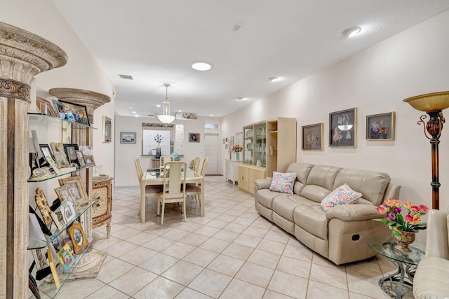living area with light tile patterned floors and visible vents