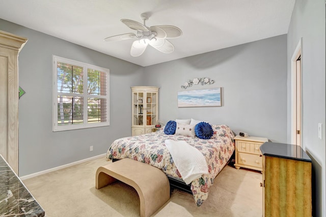 bedroom with baseboards, light colored carpet, and ceiling fan