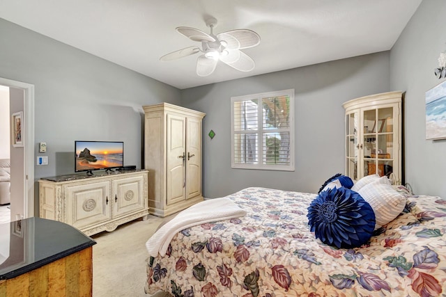 bedroom with light carpet and a ceiling fan