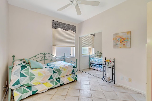 tiled bedroom with a ceiling fan and baseboards