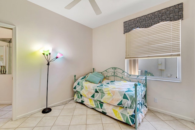 tiled bedroom featuring baseboards and ceiling fan