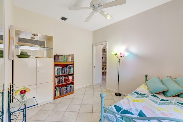 bedroom with light tile patterned floors, visible vents, baseboards, and ceiling fan