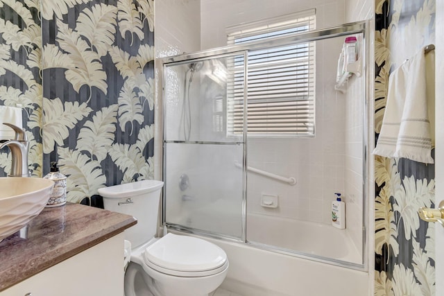 full bath with wallpapered walls, toilet, a wealth of natural light, enclosed tub / shower combo, and vanity
