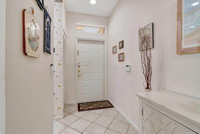 entryway with light tile patterned floors and baseboards