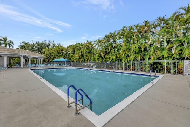 pool featuring a patio and fence