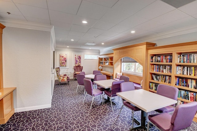 carpeted office space with crown molding, recessed lighting, baseboards, and a textured wall