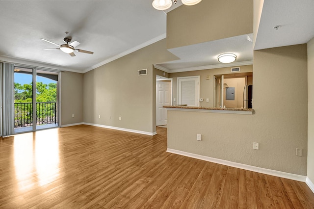 unfurnished living room featuring baseboards, visible vents, a ceiling fan, ornamental molding, and wood finished floors