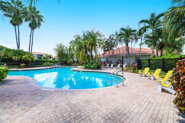 pool featuring a patio area and fence