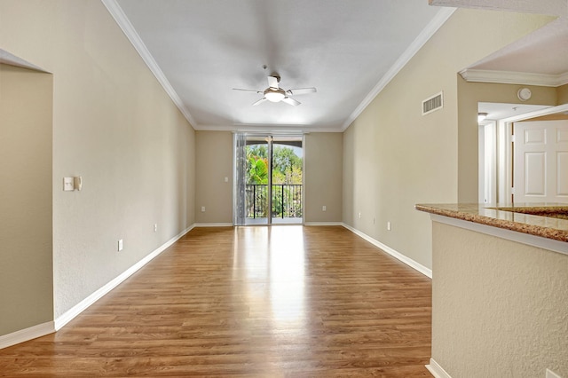 unfurnished room with crown molding, hardwood / wood-style flooring, and ceiling fan