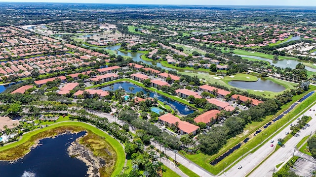 aerial view with a residential view, view of golf course, and a water view