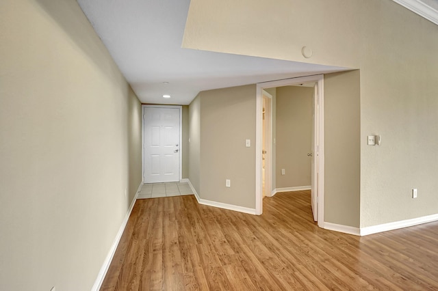 empty room with light wood-style floors and baseboards