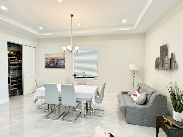 dining room featuring a tray ceiling and a notable chandelier