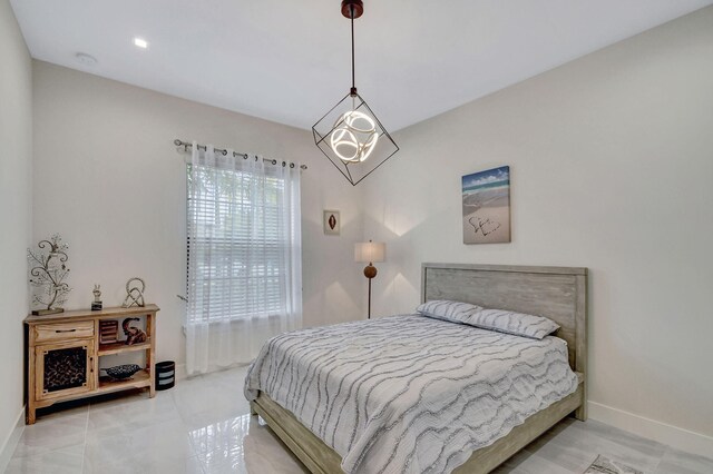 bedroom featuring a notable chandelier