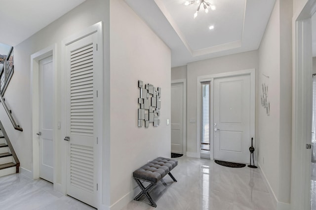 entrance foyer featuring a raised ceiling