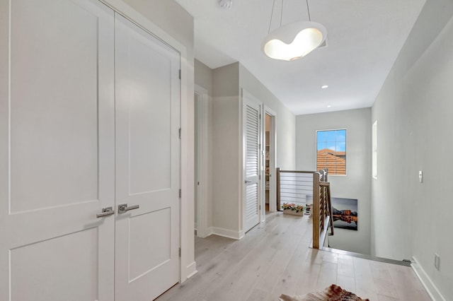 hall with light hardwood / wood-style flooring