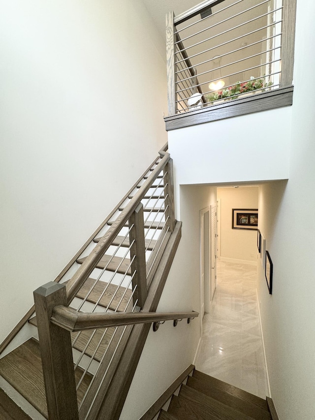 stairs featuring a towering ceiling