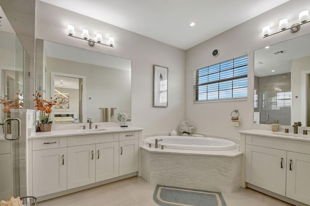 bathroom with vanity, tile patterned floors, and plus walk in shower