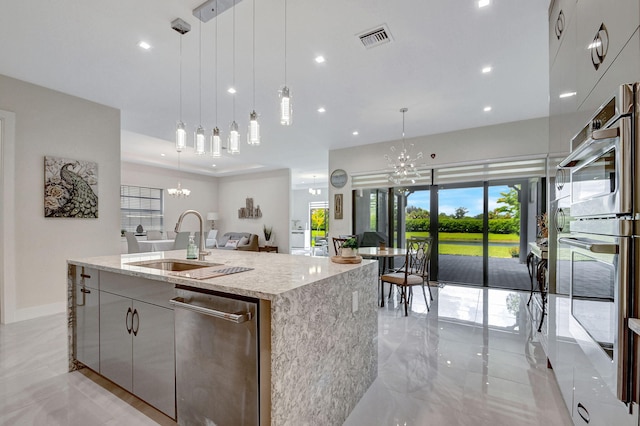 kitchen with a large island, a chandelier, and hanging light fixtures