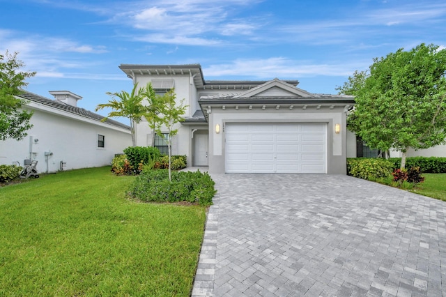 view of front facade featuring a garage and a front lawn