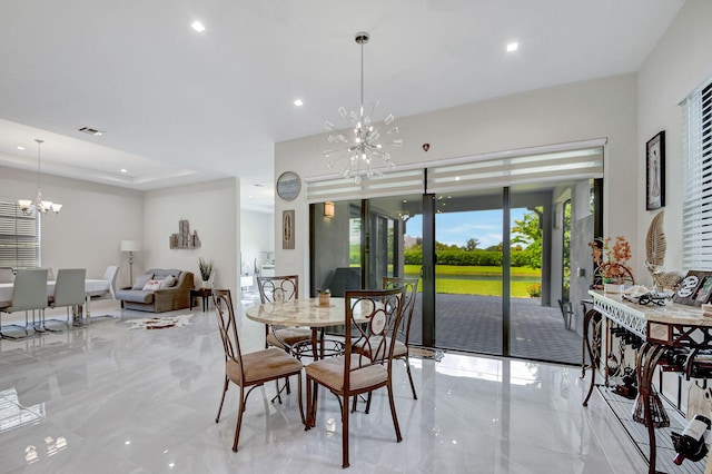 dining space featuring a notable chandelier and a tray ceiling