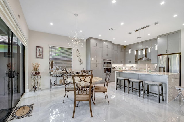 dining area with a chandelier and sink