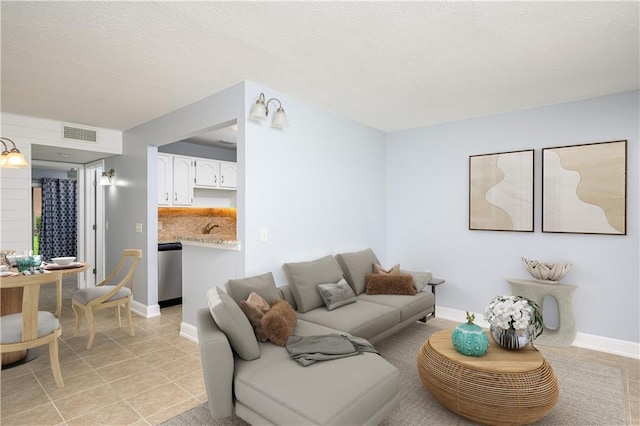 living room with sink and light tile patterned flooring