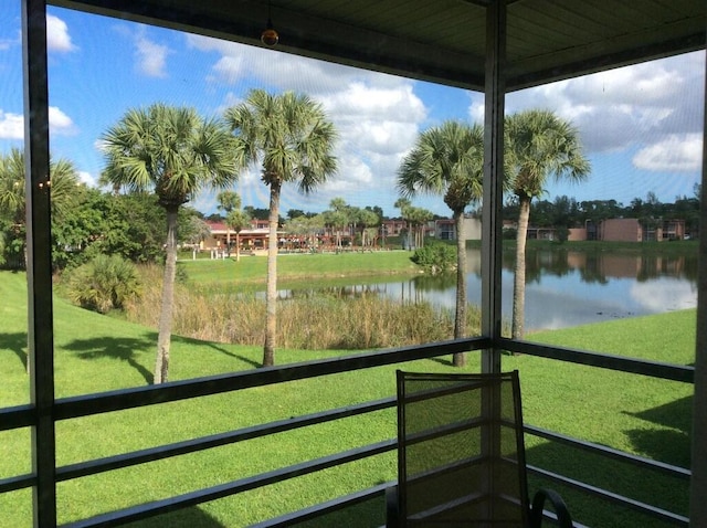 unfurnished sunroom with a water view