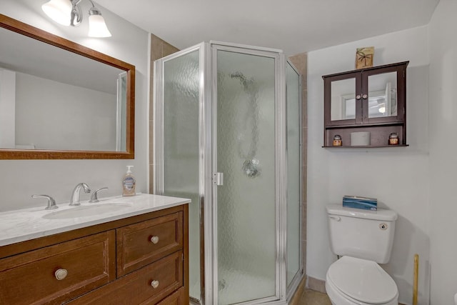 bathroom featuring a stall shower, vanity, and toilet