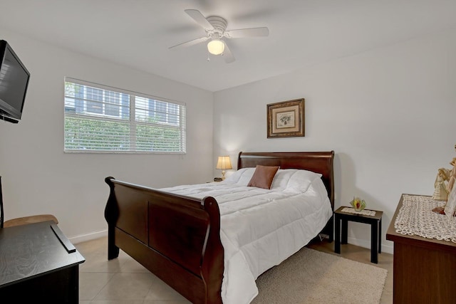 bedroom with a ceiling fan, baseboards, and light tile patterned floors