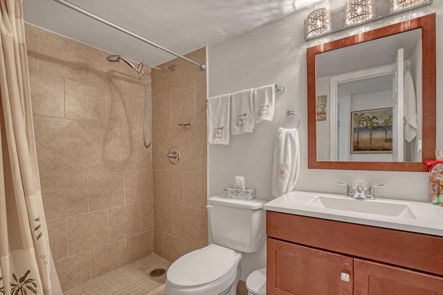 full bathroom with vanity, a shower stall, and toilet