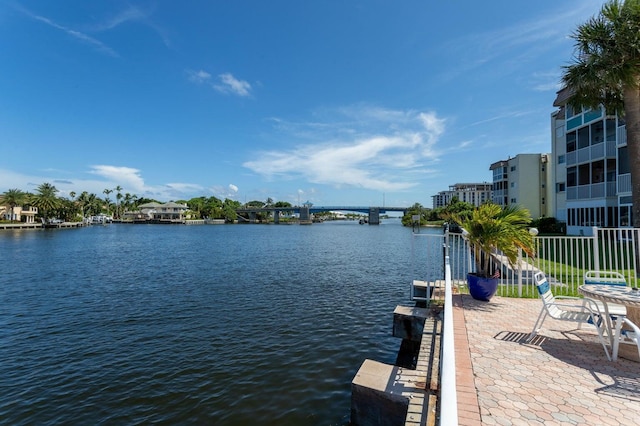 view of dock featuring a water view and fence