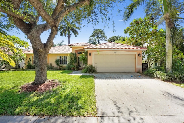 view of front of property featuring a front yard and a garage