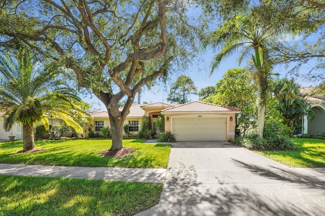 mediterranean / spanish home featuring a front lawn and a garage