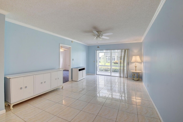 tiled spare room with a textured ceiling, ornamental molding, and ceiling fan