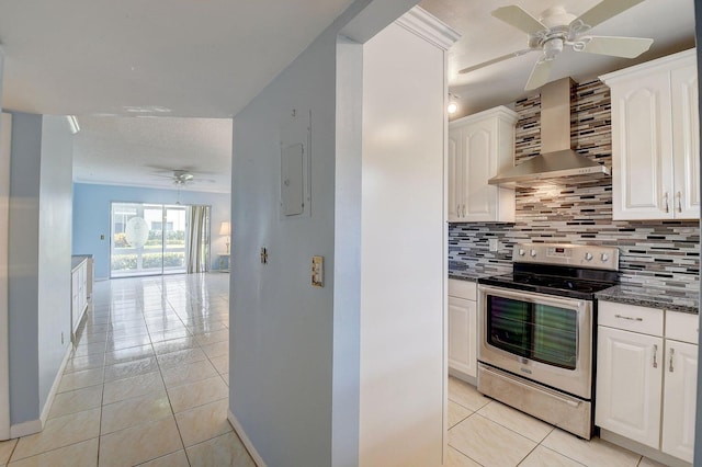 kitchen with white cabinets, wall chimney range hood, electric range, and decorative backsplash