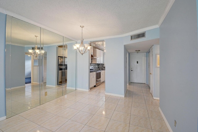 interior space with ornamental molding, a chandelier, a textured ceiling, and light tile patterned floors