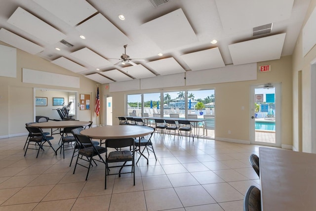 dining space with light tile patterned flooring, ceiling fan, and high vaulted ceiling