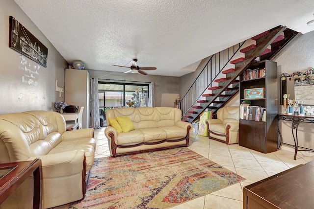 tiled living room with a textured ceiling and ceiling fan