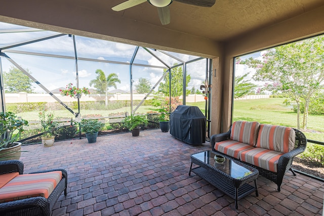 sunroom / solarium featuring ceiling fan