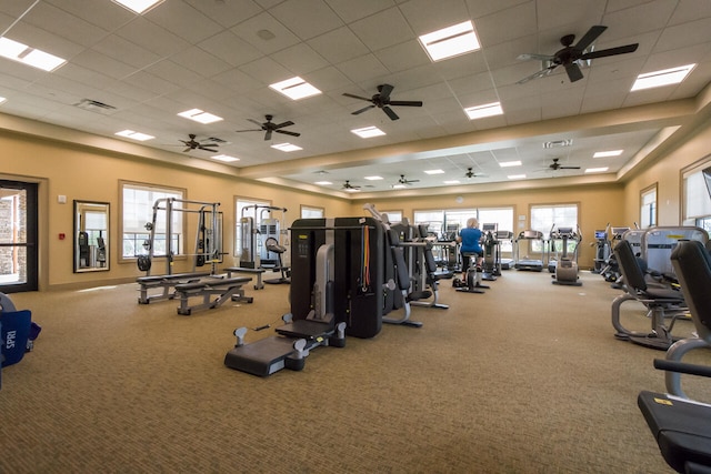 gym featuring light colored carpet, a paneled ceiling, and ceiling fan