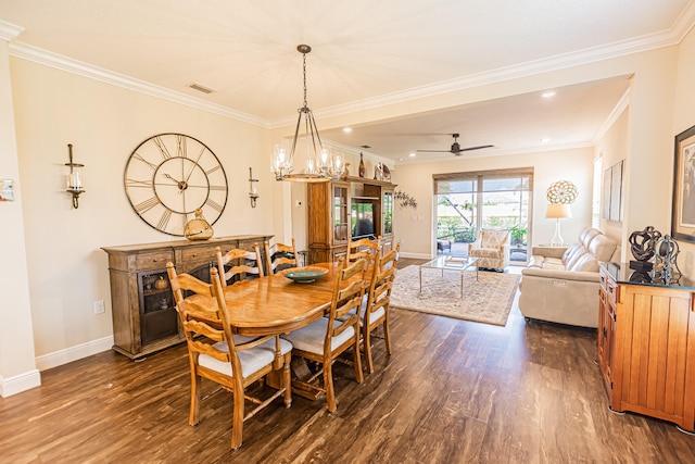 dining room with crown molding, dark hardwood / wood-style flooring, and ceiling fan with notable chandelier