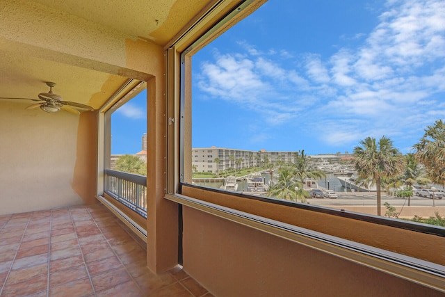 unfurnished sunroom featuring ceiling fan