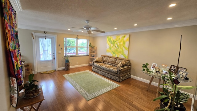 living room with wood-type flooring and ornamental molding