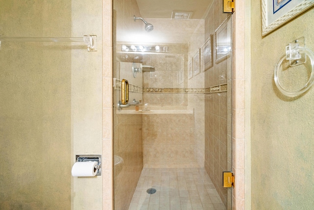 bathroom featuring a shower with shower door