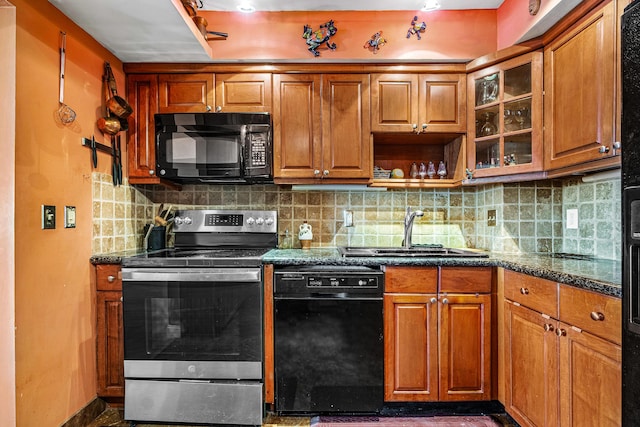 kitchen featuring black appliances, backsplash, sink, and dark stone counters