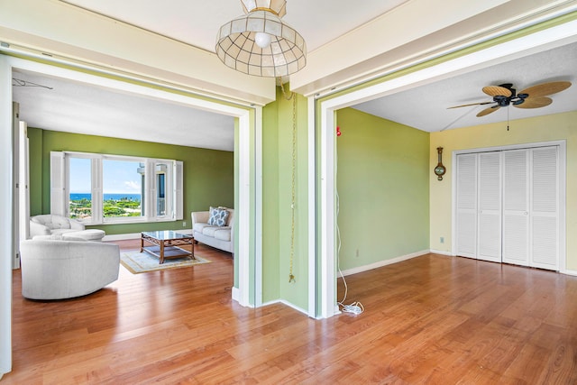 living room featuring ceiling fan and wood-type flooring